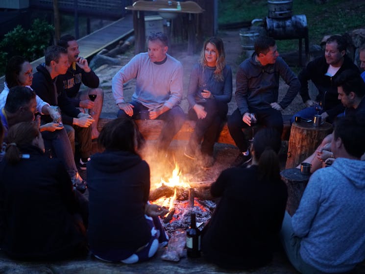 Group sitting around the campfire on a multi-day adventure in the Blue Mountains, NSW
