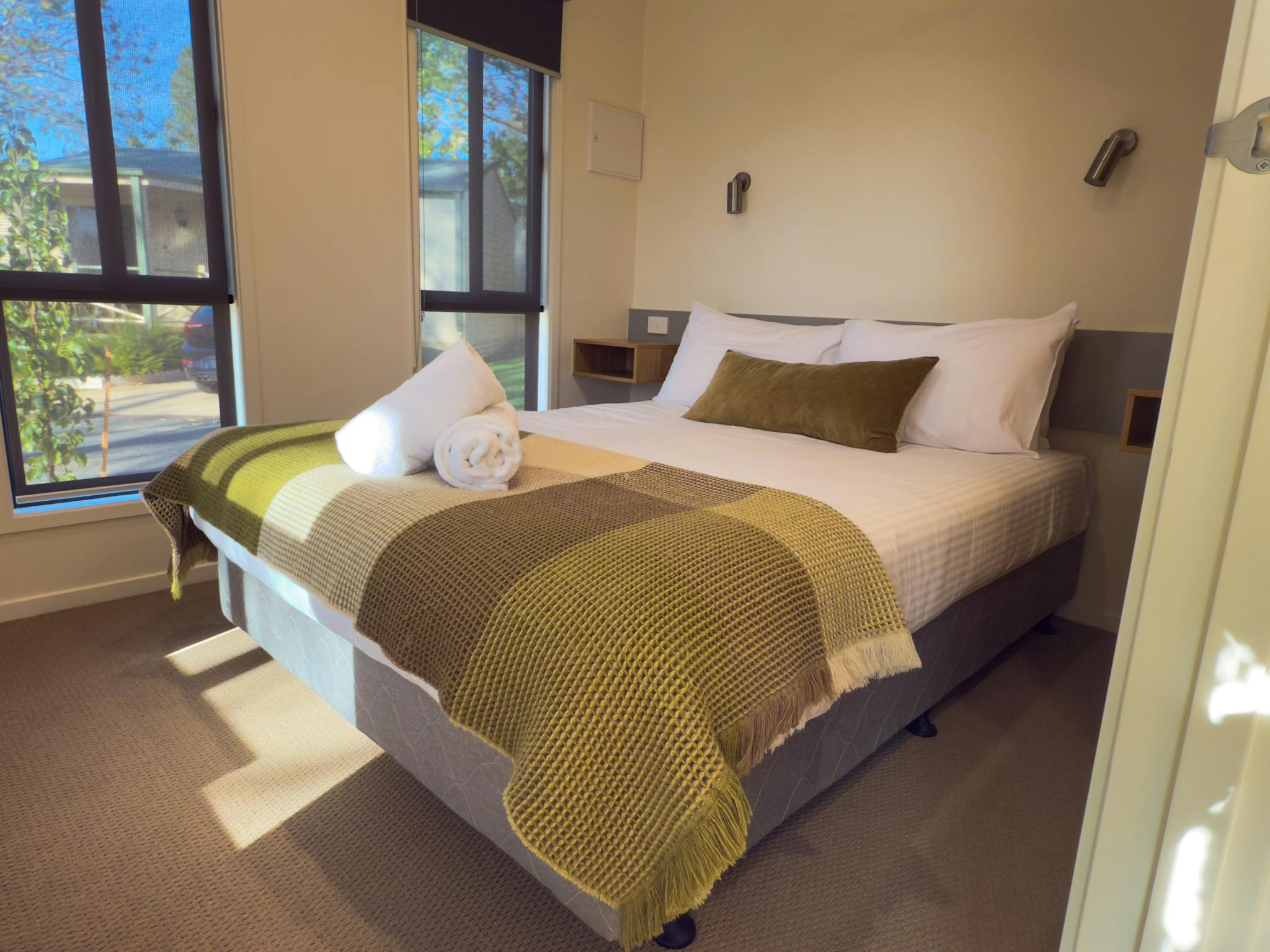 A double bed in the main bedroom of the deluxe cabin