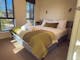 A double bed in the main bedroom of the deluxe cabin