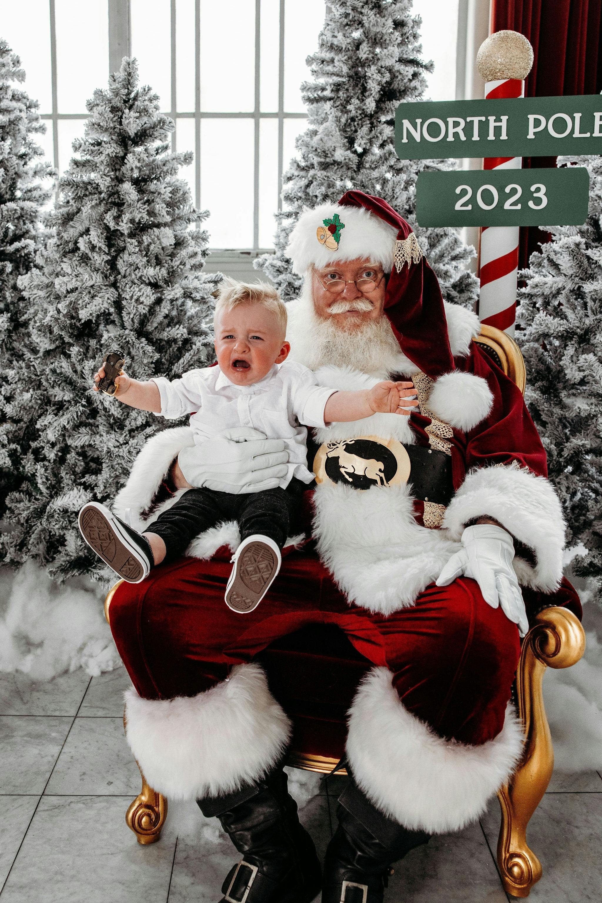 baby crying while sitting on santas lap