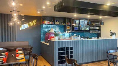 Internal view of empty restaurant with yellow Divine light on wall