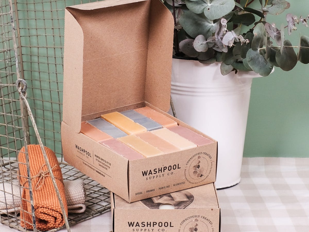Image of Washpool's soap boxes containing 10 handmade soap, surrounded by eucalyptus plan in vase.