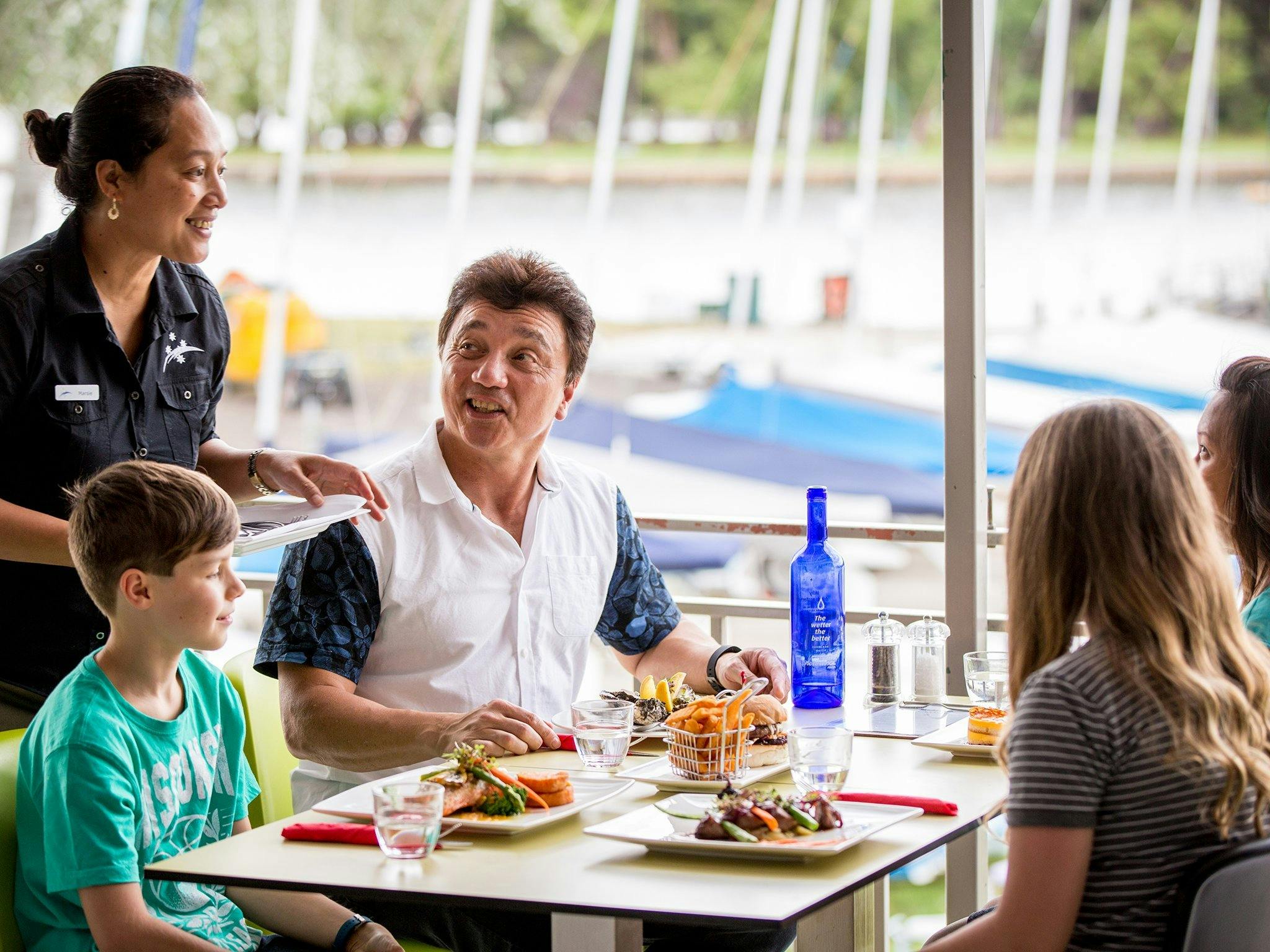 Family enjoying a meal overlooking the lake