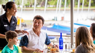 Family enjoying a meal overlooking the lake