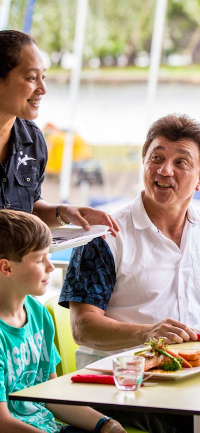 Family enjoying a meal overlooking the lake