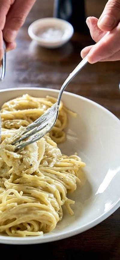 Plate of spaghetti on restaurant table