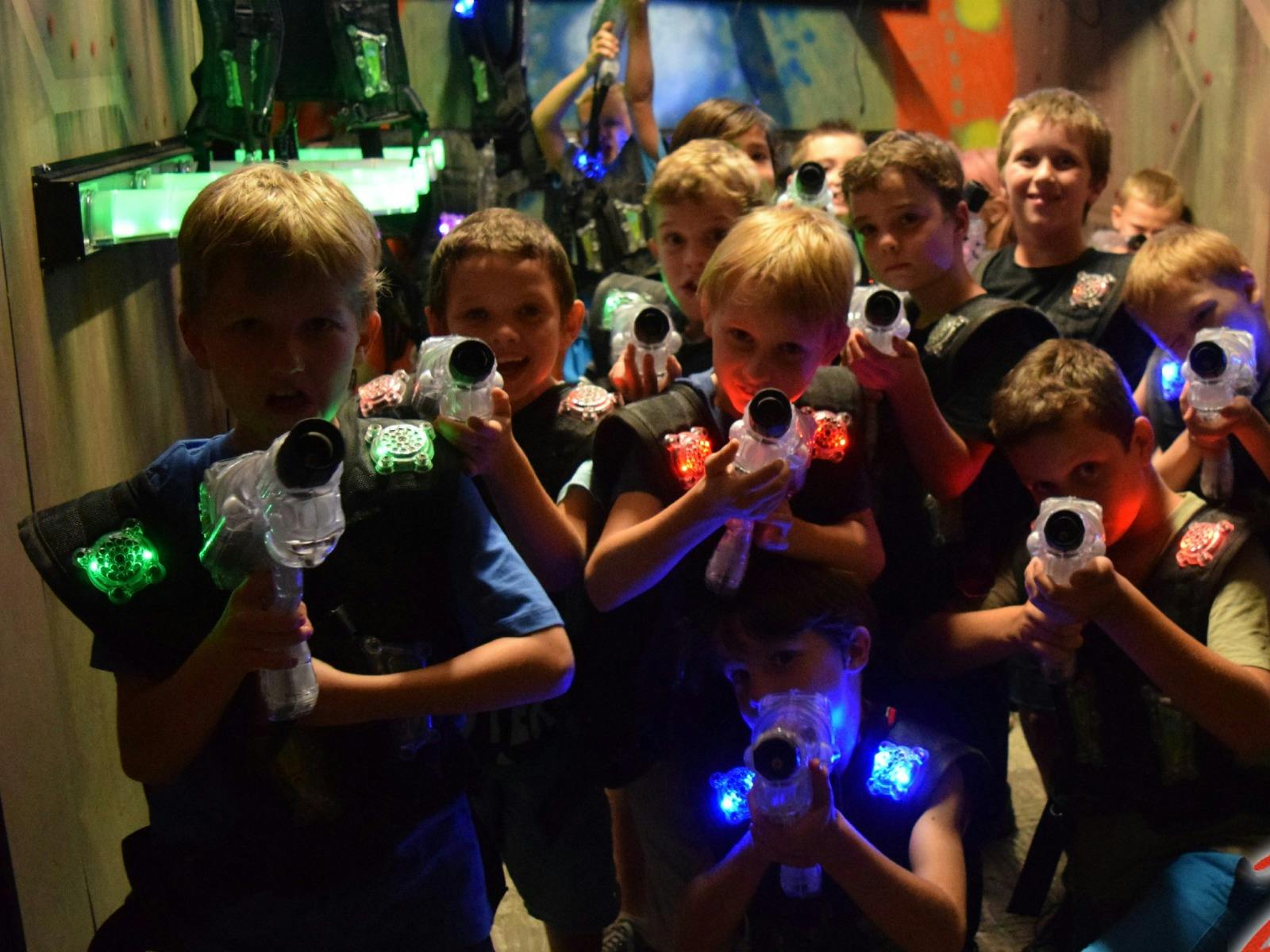 kids posing with laser tag phasors