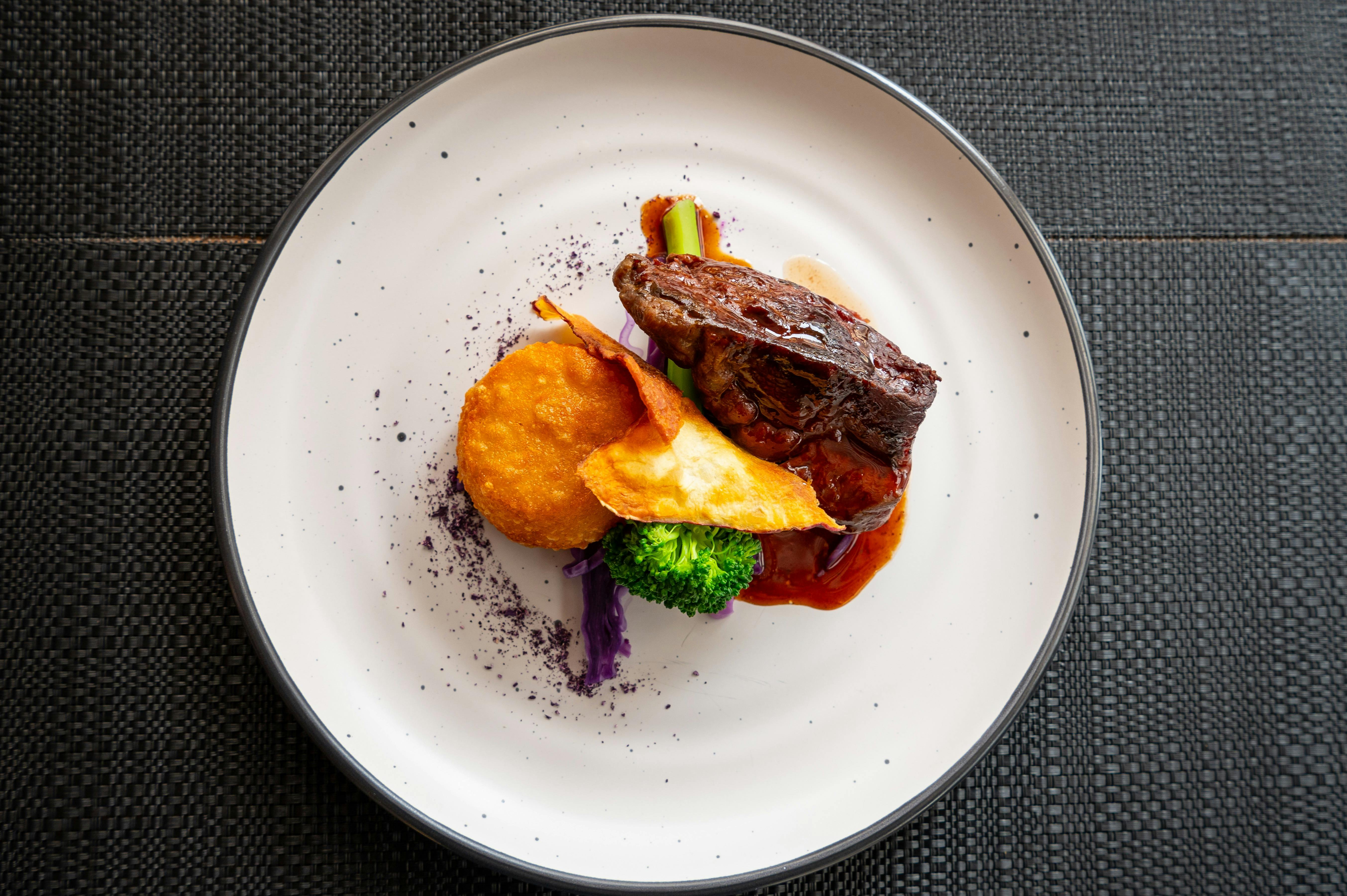 Gourmet main dish of red meat with colourful roast veg