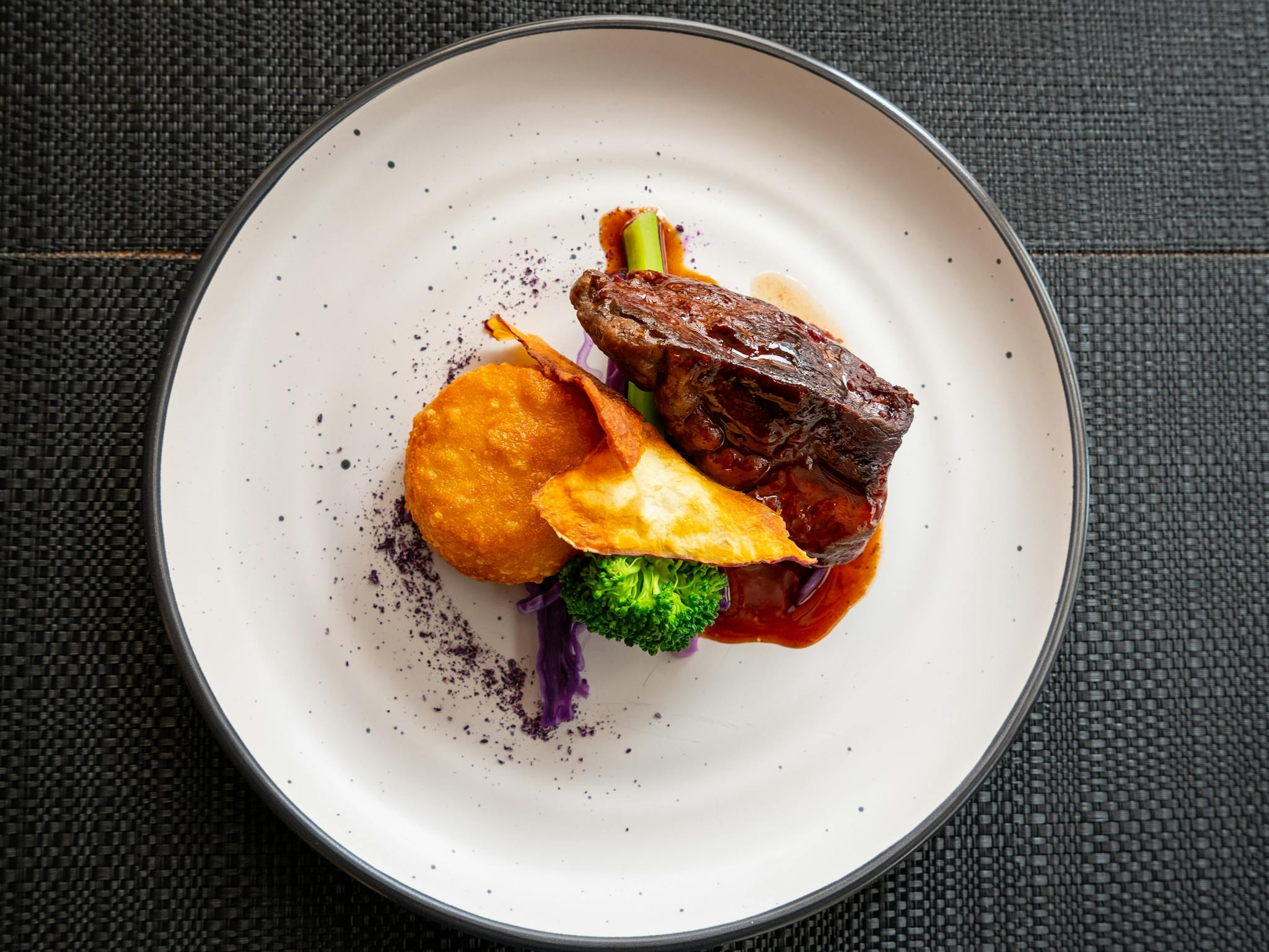 Gourmet main dish of red meat with colourful roast veg