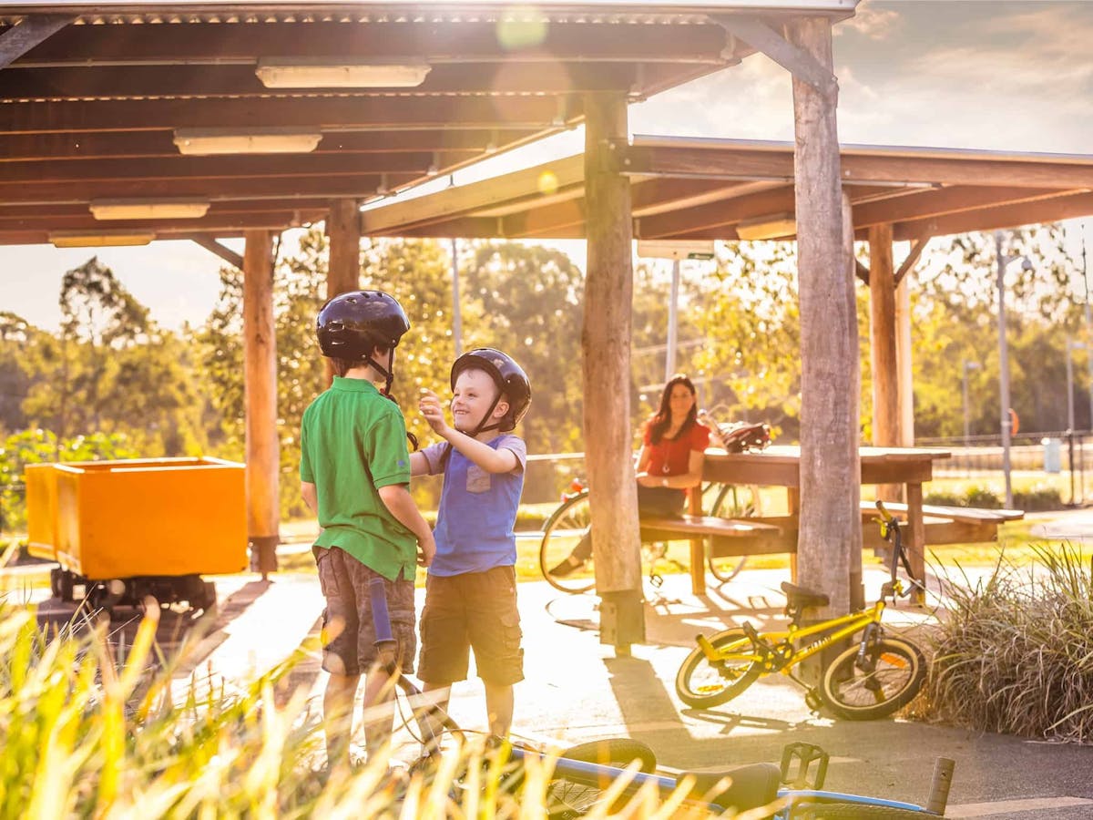 Family resting under shelter during bike ride.