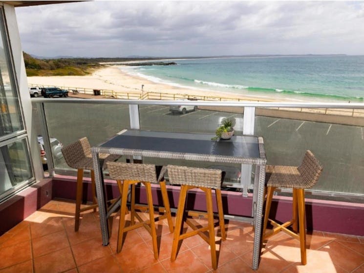 Balcony with incredible beach views and high table setting