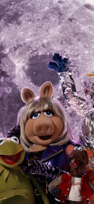 Six puppets looking excited at the camera with a planet in the background