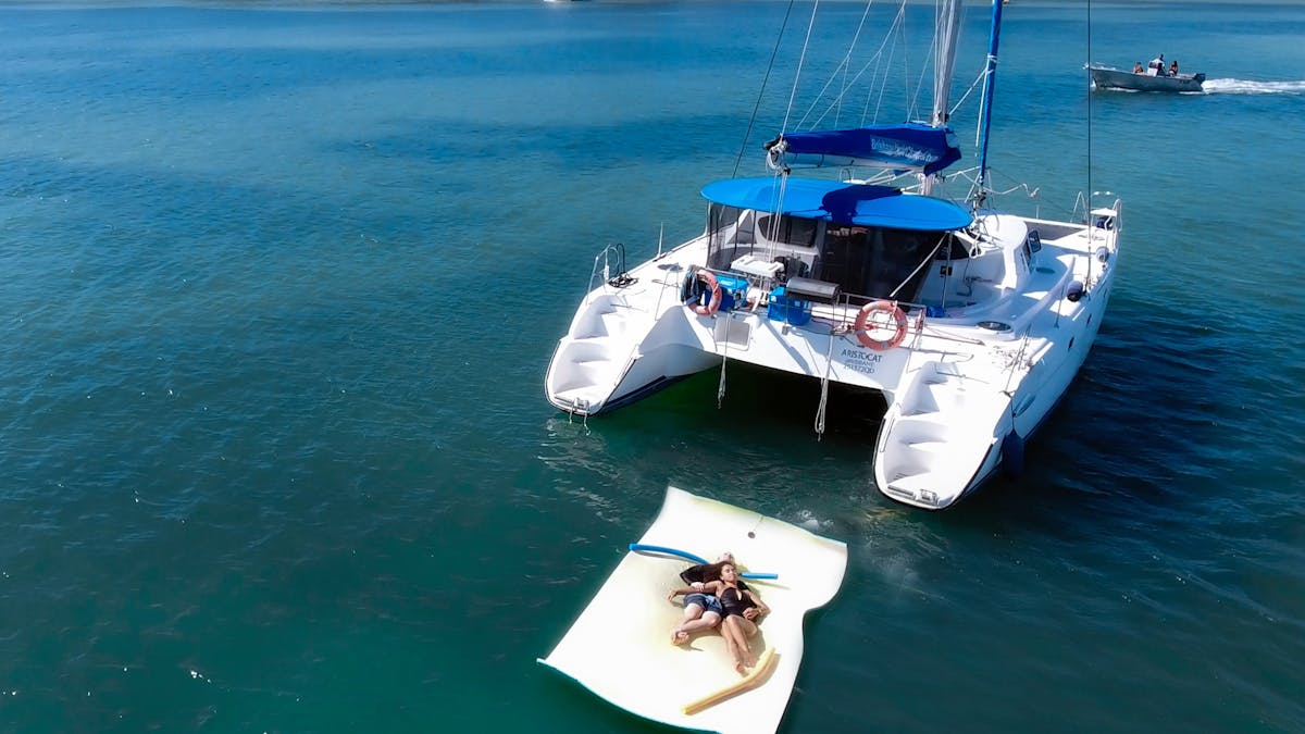 A couple swimmiing the calm waters of Horseshoe Bay in Moreton Bay with Brisbane Yacht Charters
