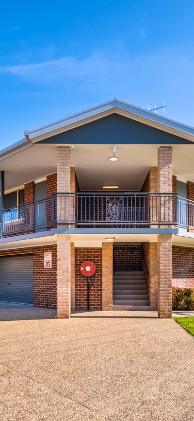 River Motel Suites' historic exterior, with undercover garage parking under each suite.