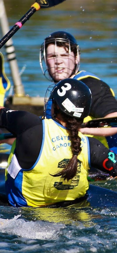 One player in goals has their paddle up, whilst the opposition is ready to shoot the ball