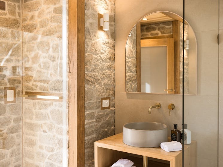 luxury bathroom with stone walls