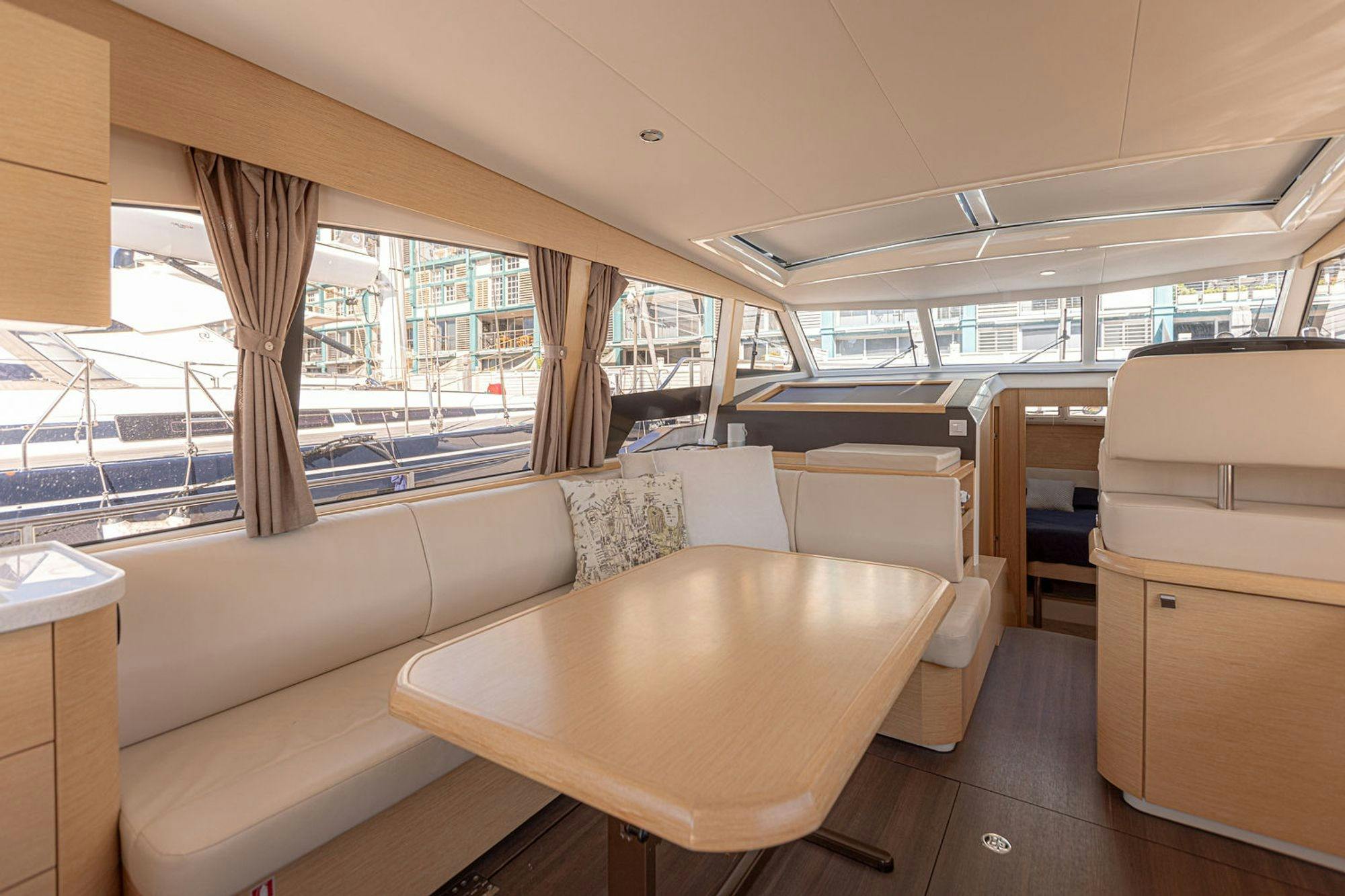 EV Arcadia luxury saloon dining table with cream leather seating and skylight Sydney