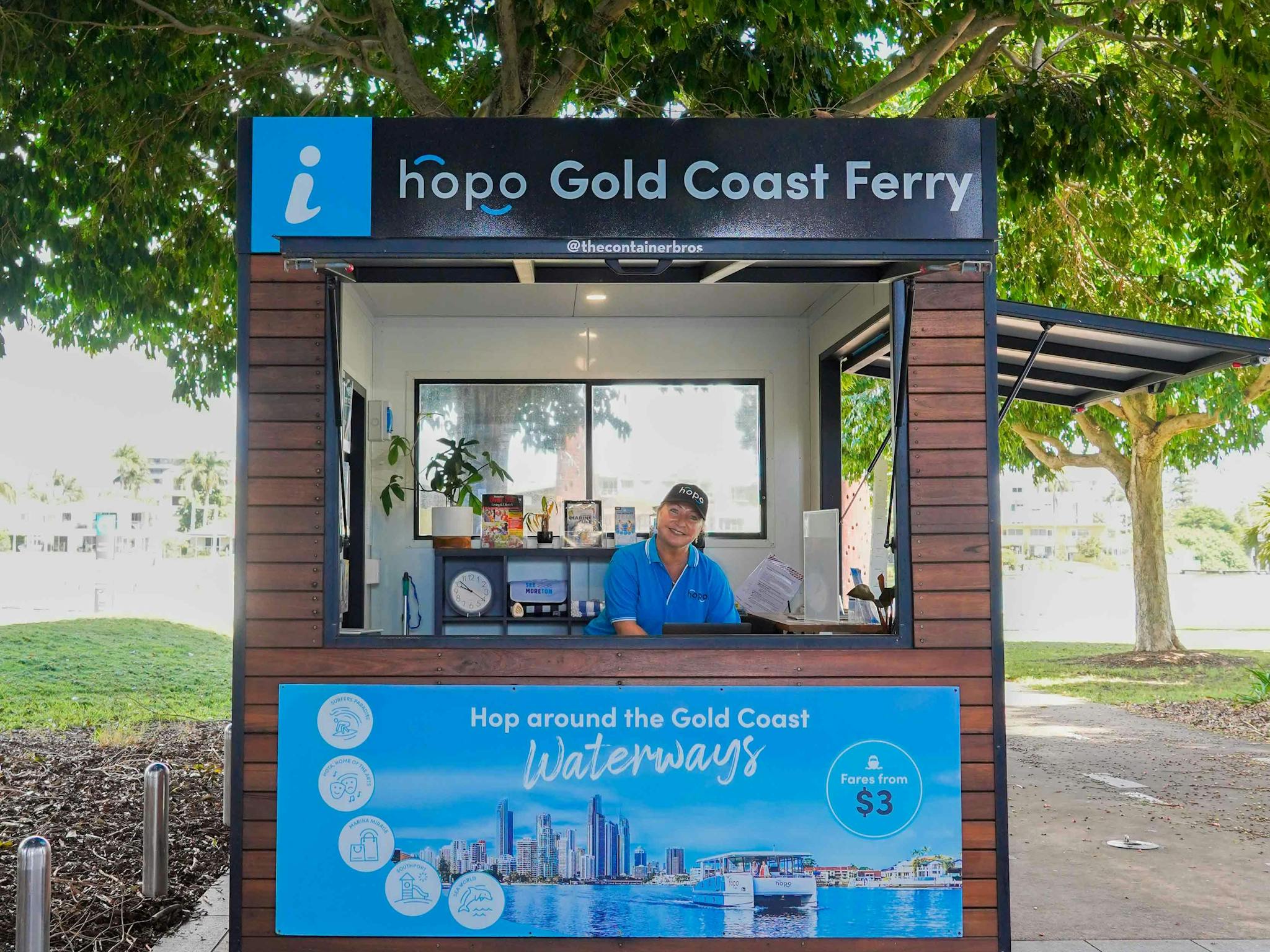 Woman in blue Hopo shirt stands inside Hopo Information Kiosk Woman in blue Hopo shirt stands inside Hopo Information Kiosk