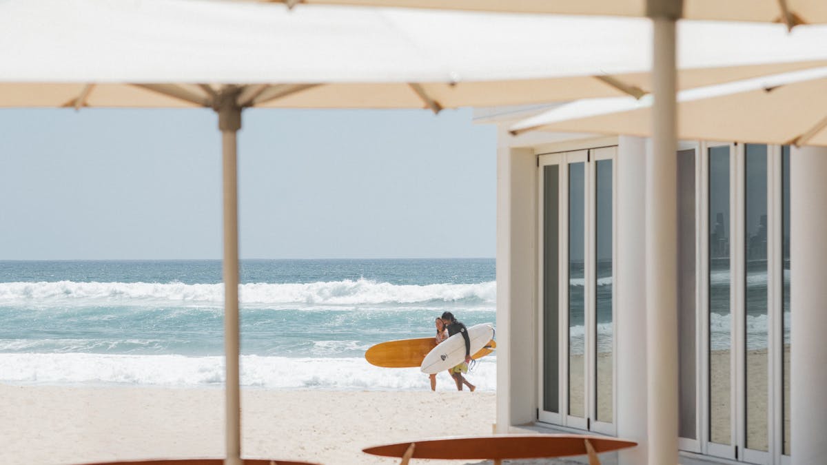 Rick Shore's Patio with surfers walking in the backgroup