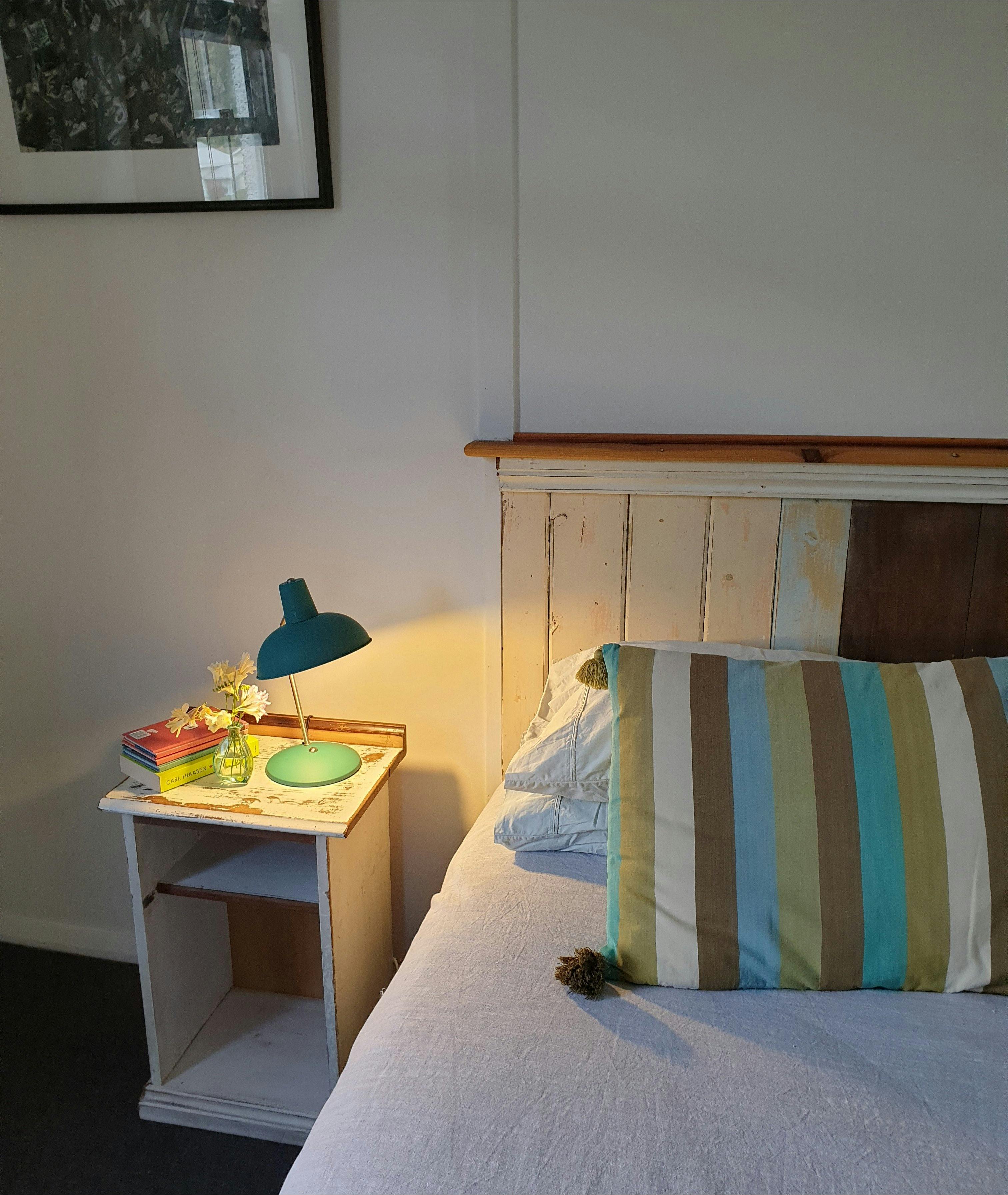 Bed with bedside table made from recycled timber