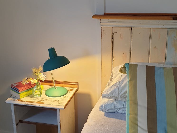 Bed with bedside table made from recycled timber