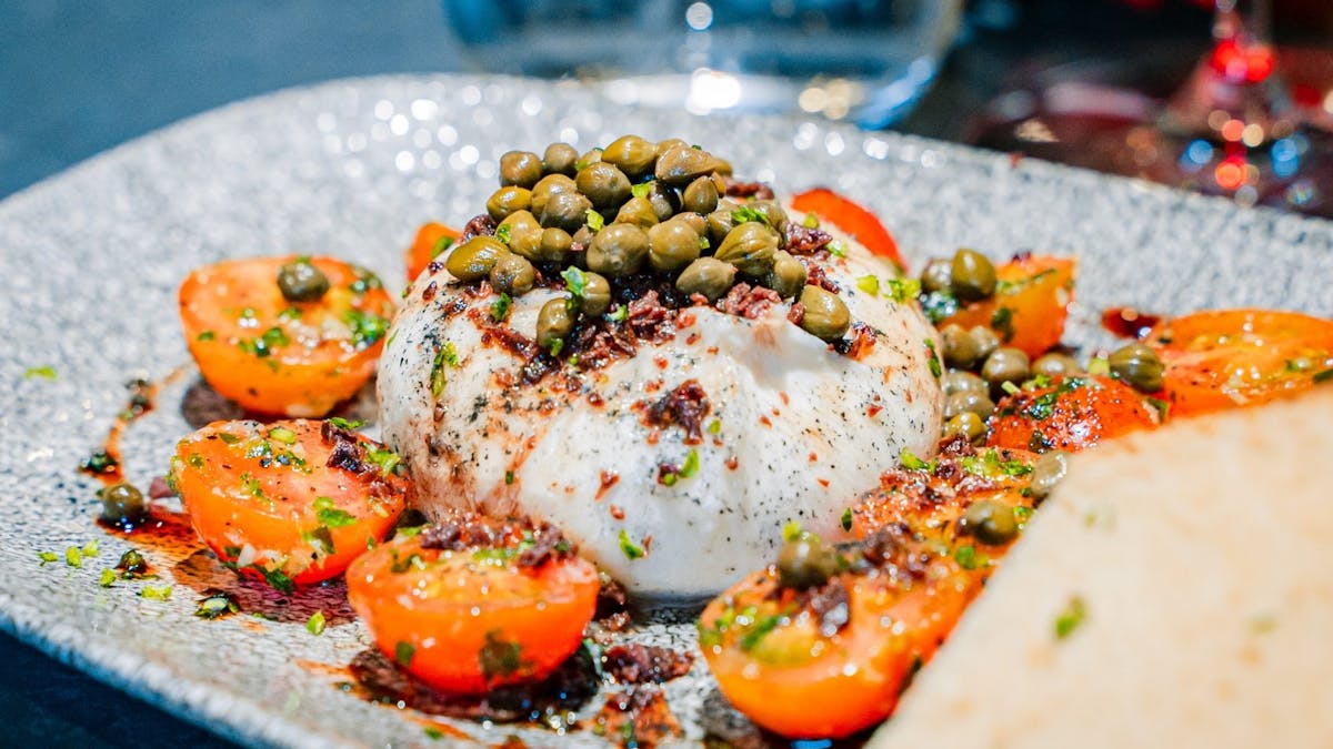 Burrata with cherry tomatoes and capers