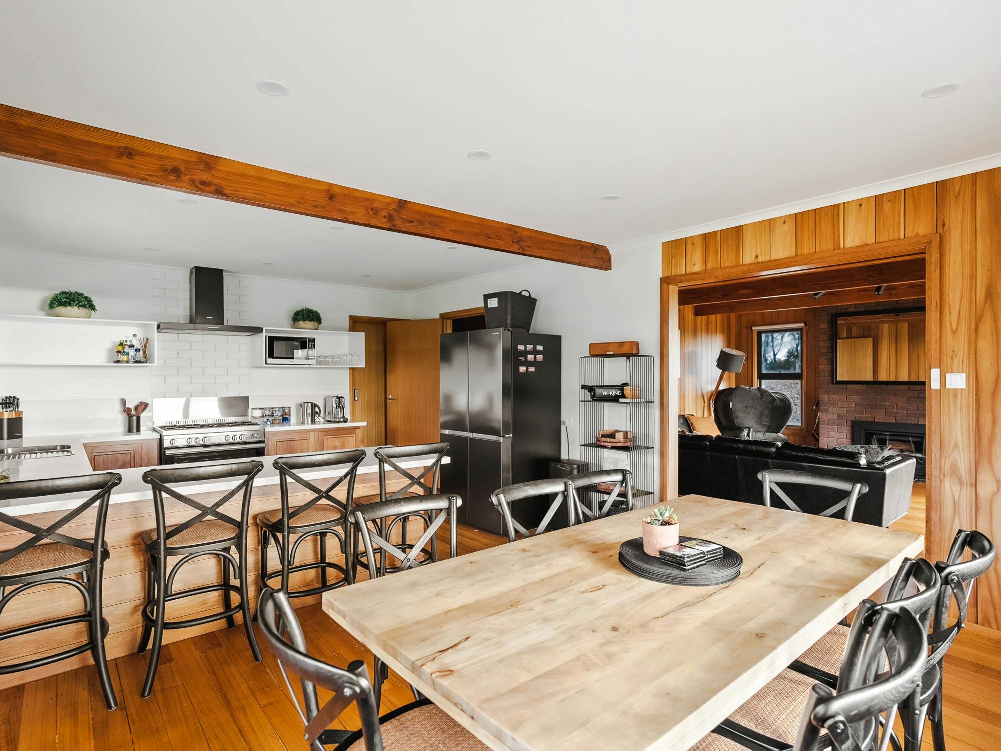 A view of the modern, fully-equipped guest kitchen with a large island and bar stools.