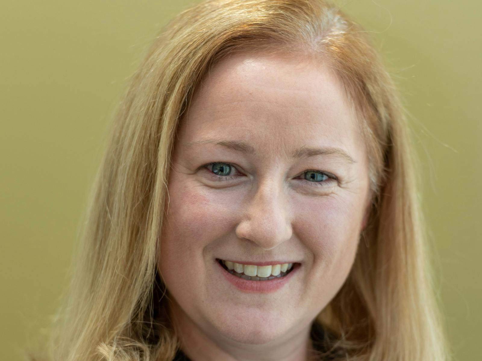 A woman with blonde hair smiling