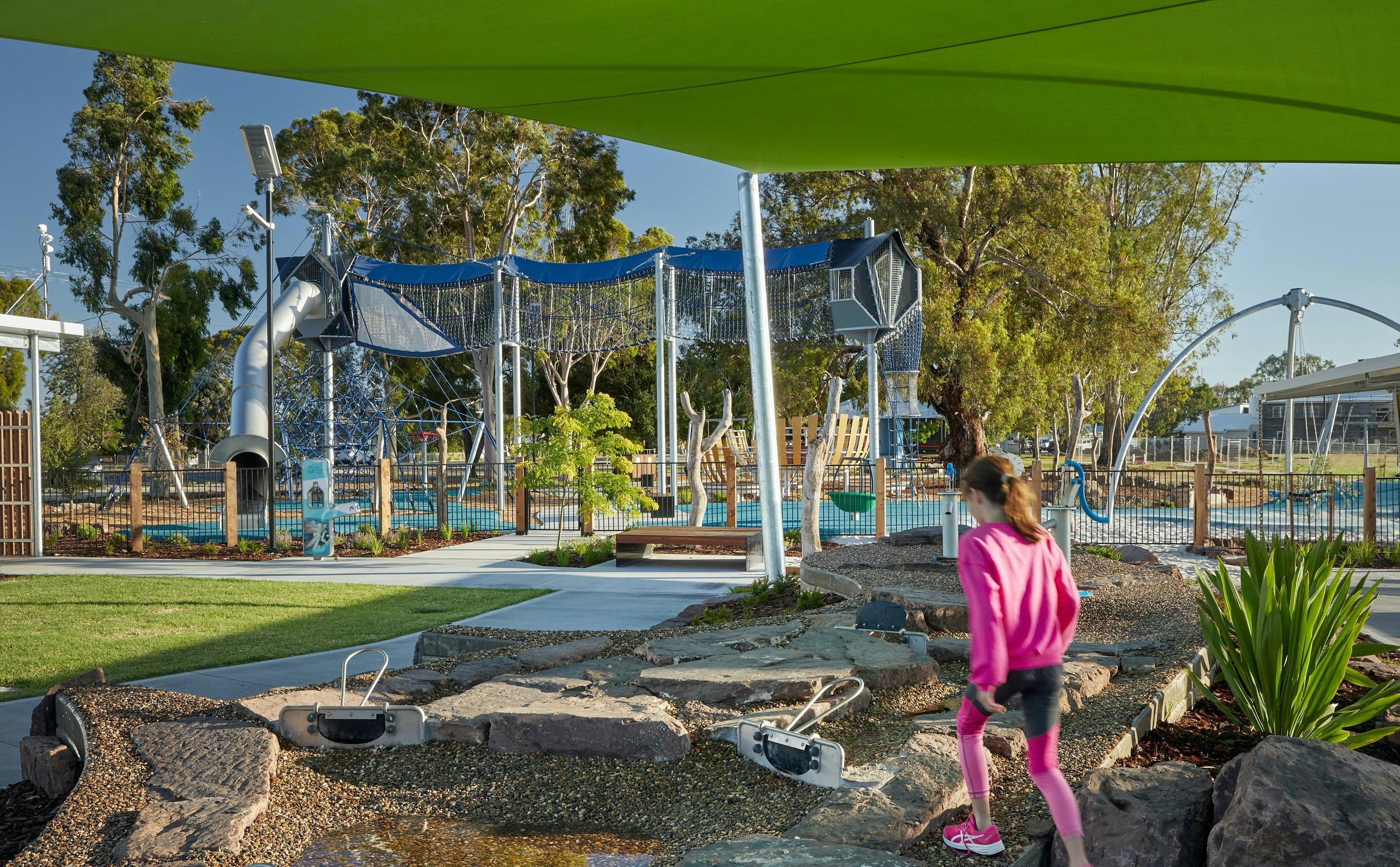 A young girl walks through a playground towards an aerial walkway at Purtle Park, Mulwala.
