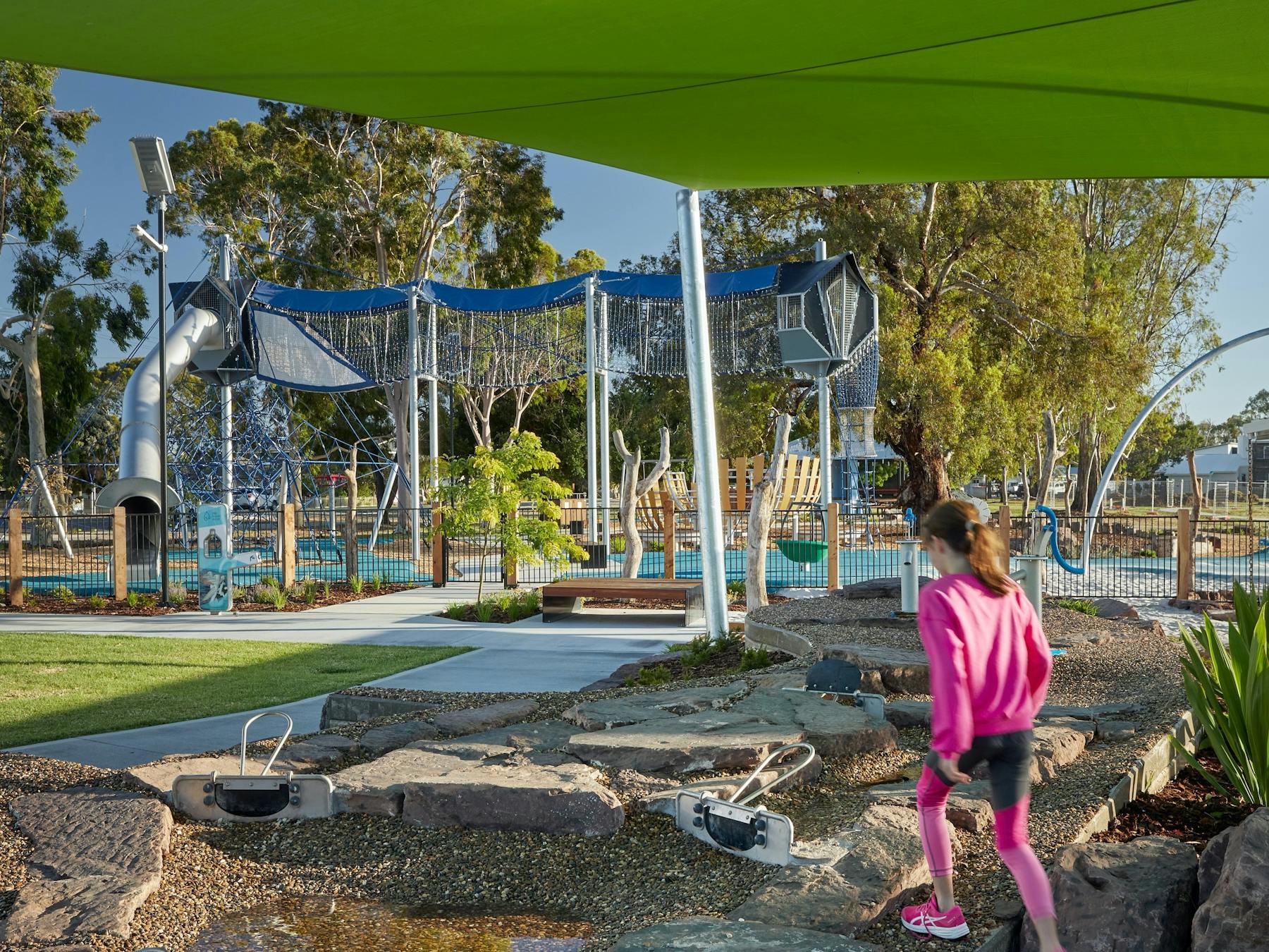 A young girl walks through a playground towards an aerial walkway at Purtle Park, Mulwala.