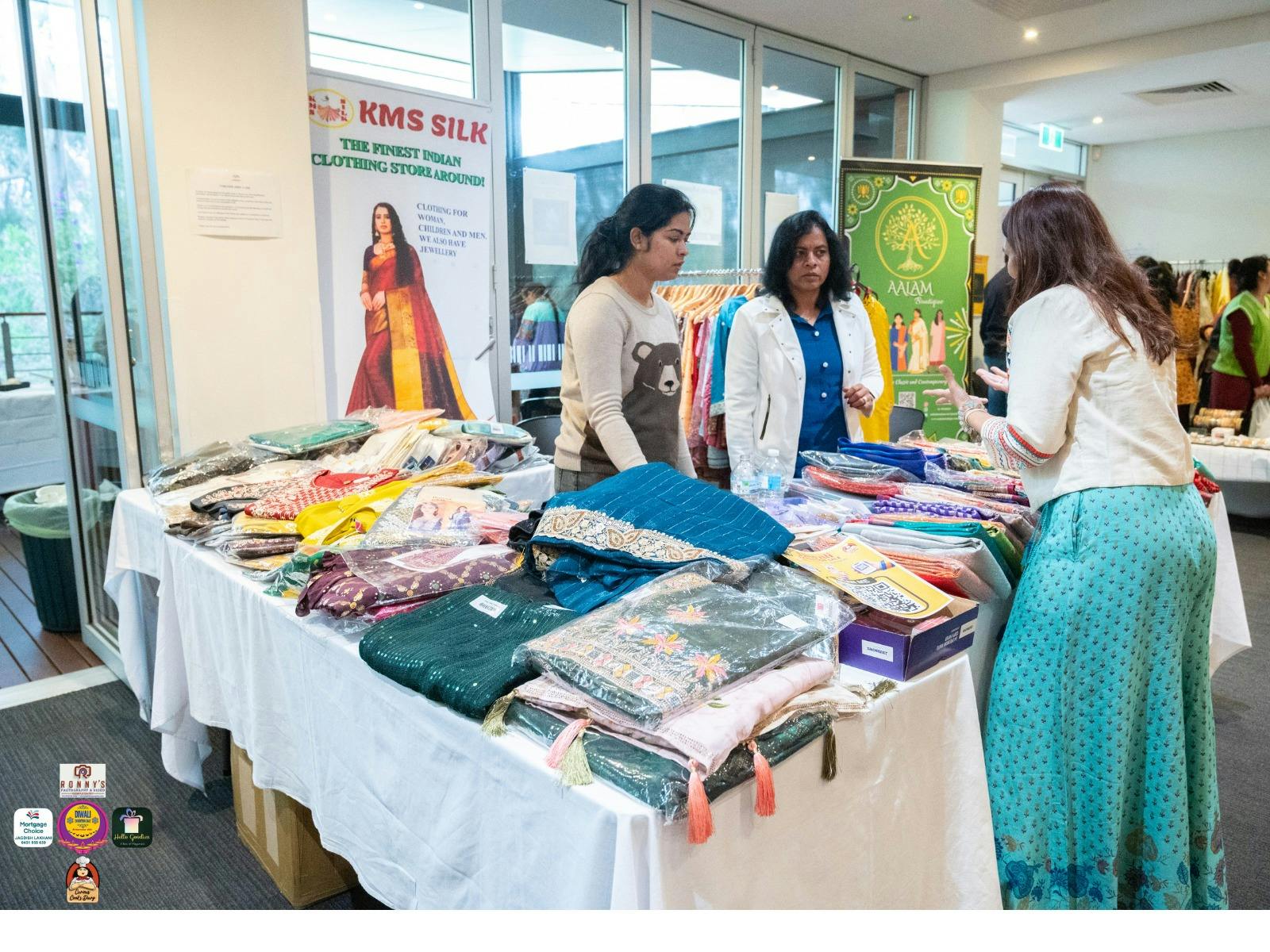 Visitor browsing traditional Indian clothing at a stall
