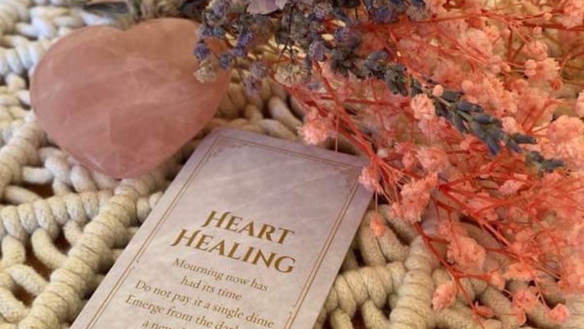 Dried flowers with tarot card and heart crystal