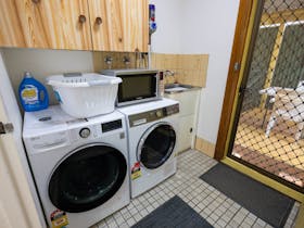 A modern washing machine and tumble dryer are supplied along with all laundry essentials