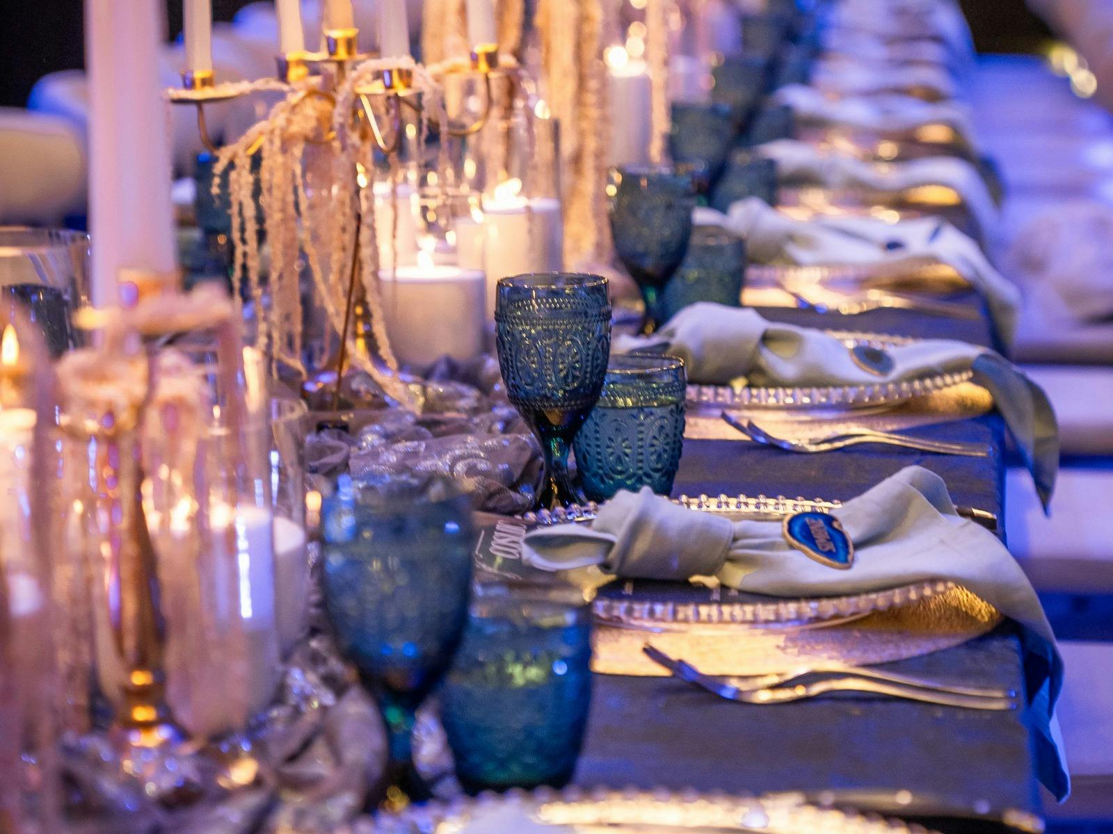 An elaborate table setting in shades of blue