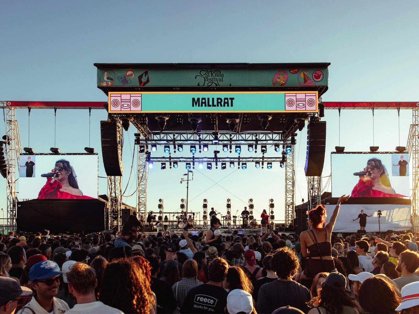 Australian artist Mallrat performs on a large stage on the St Kilda foreshore to a packed crowd.