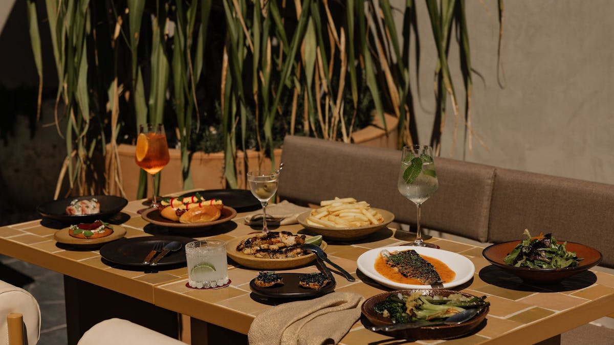 Norte patio with a table full of food and drinks