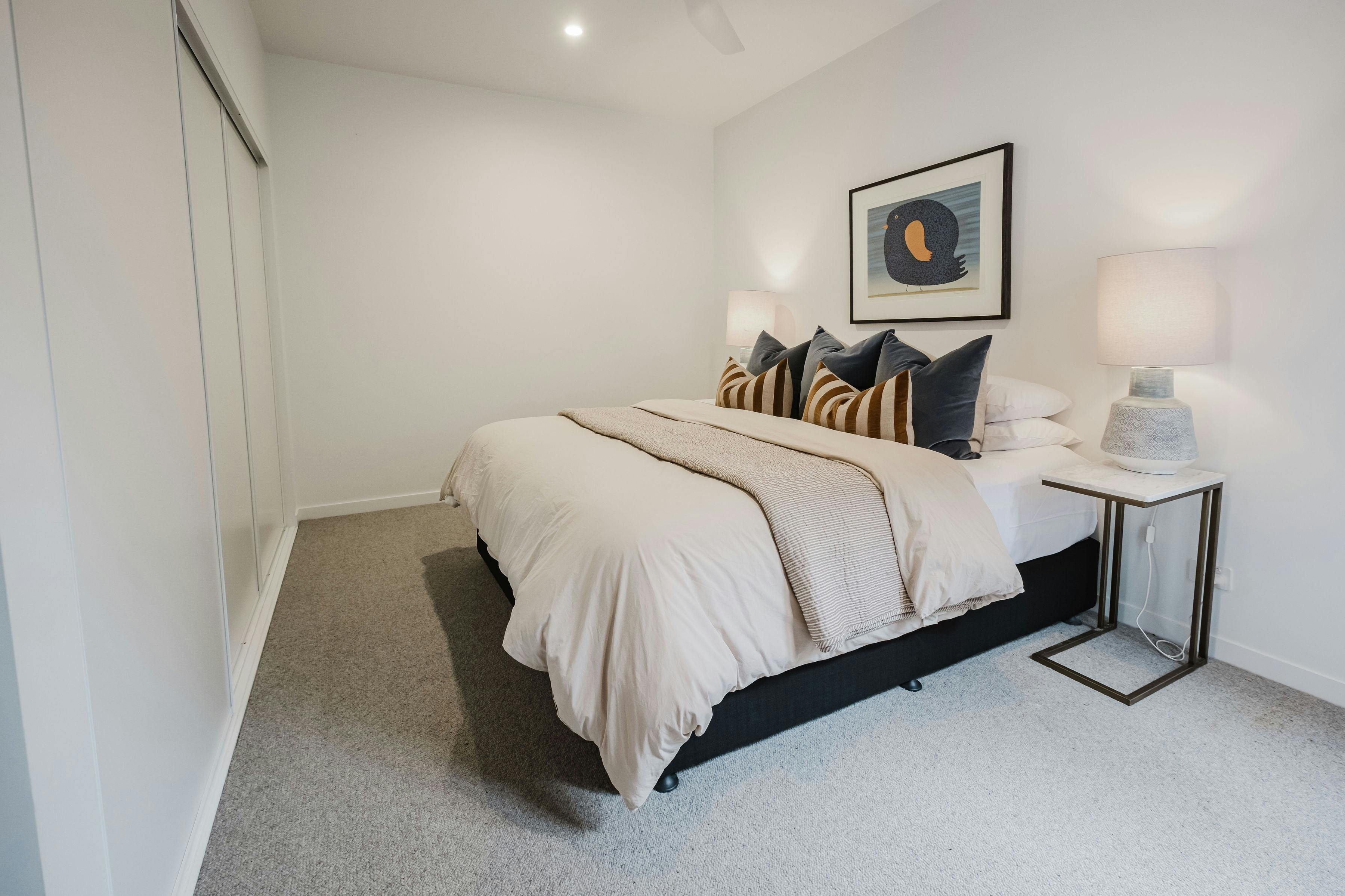 Hester arthouse townhouse bedroom with table side lamp and paintin