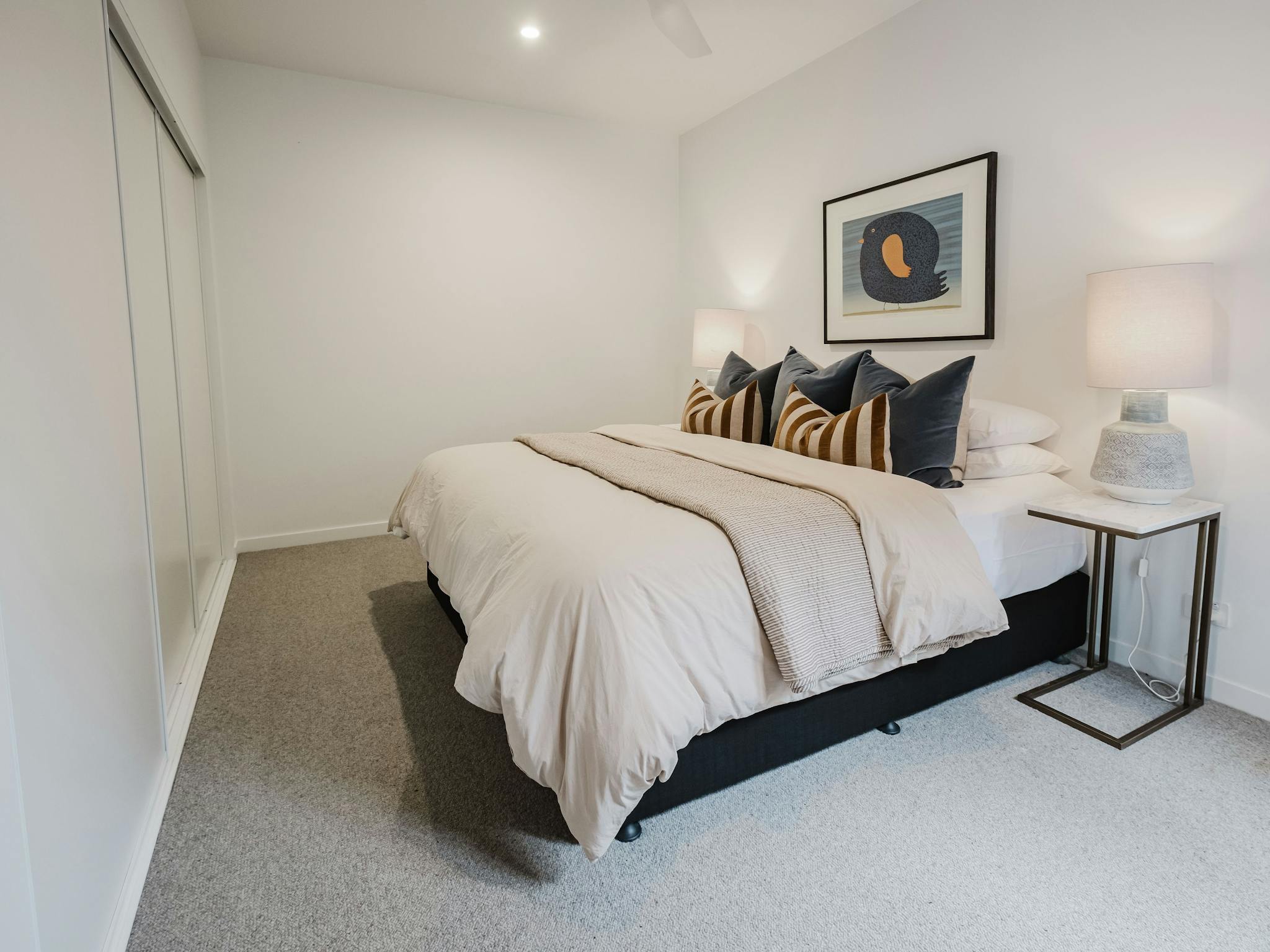 Hester arthouse townhouse bedroom with table side lamp and paintin