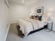 Hester arthouse townhouse bedroom with table side lamp and paintin