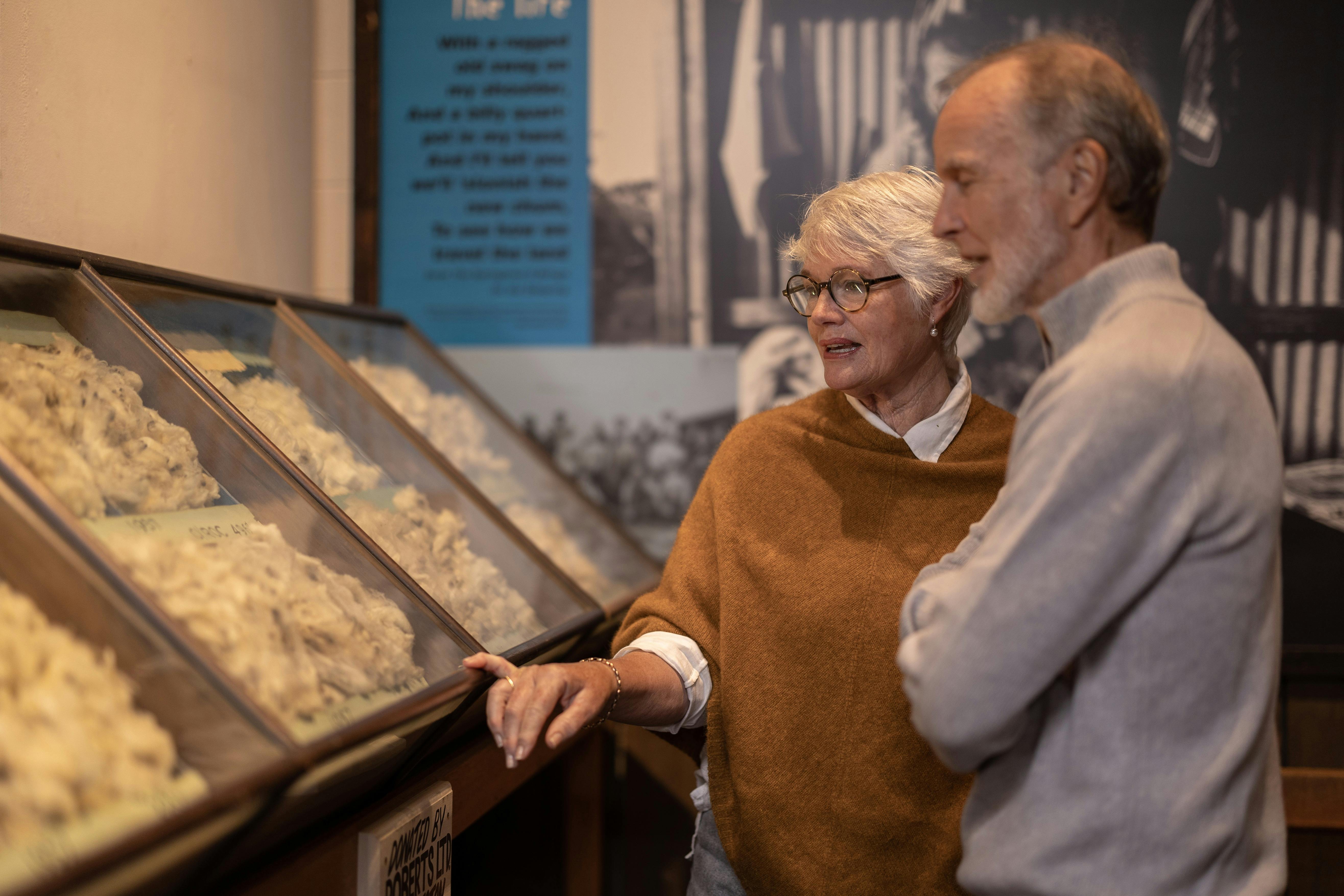 Two people admiring fleece samples in the museum's Wool Room