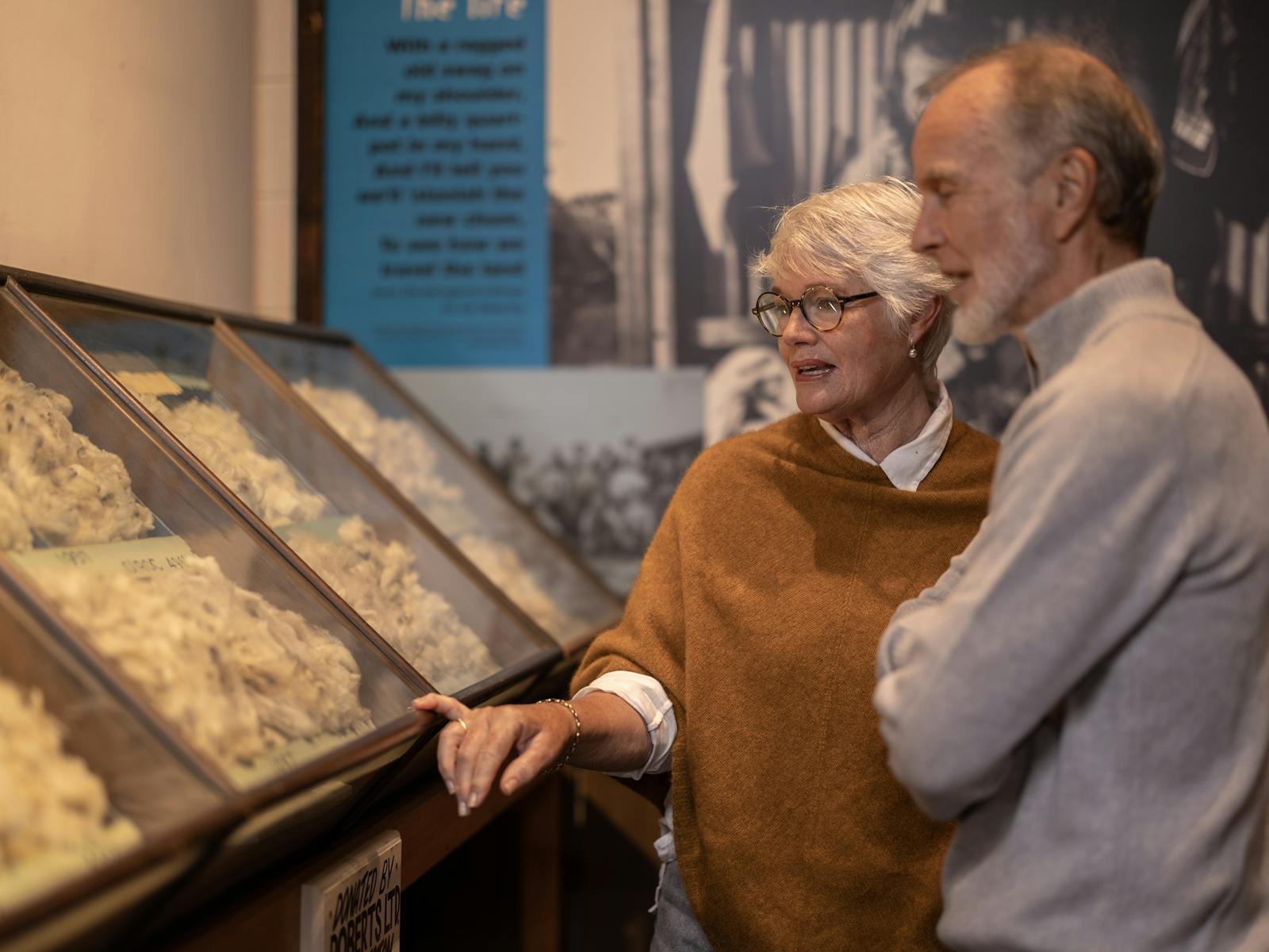 Two people admiring fleece samples in the museum's Wool Room
