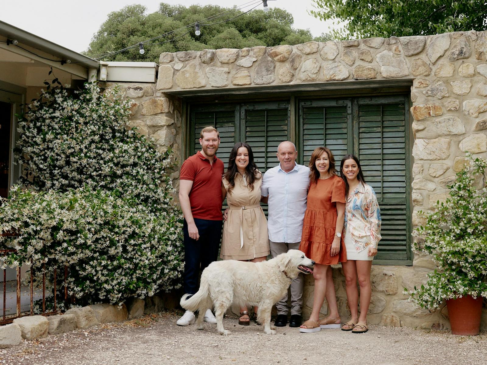 Image of Bottin family in front of stone wall