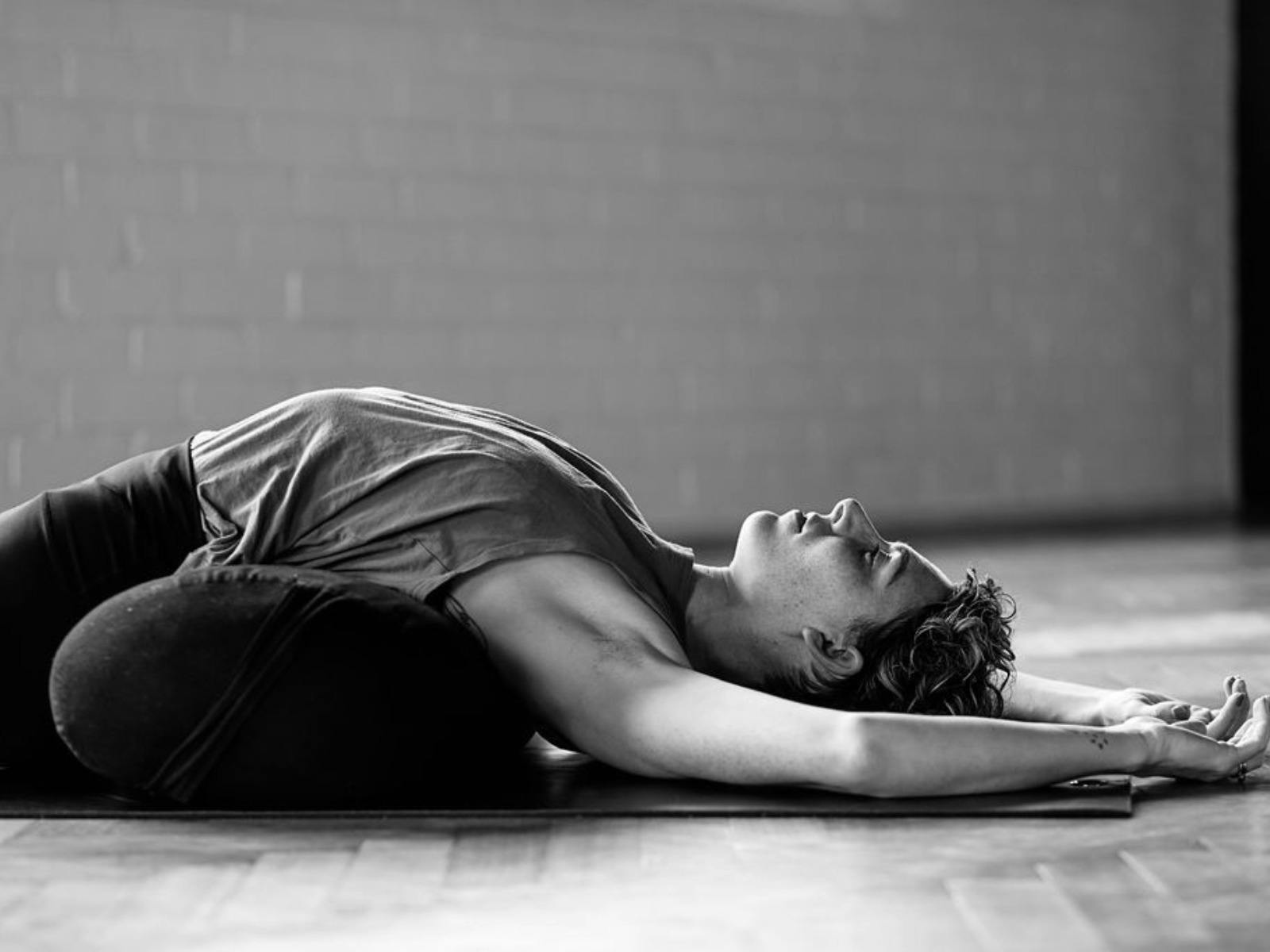 Peaceful woman laying on the floor during yoga