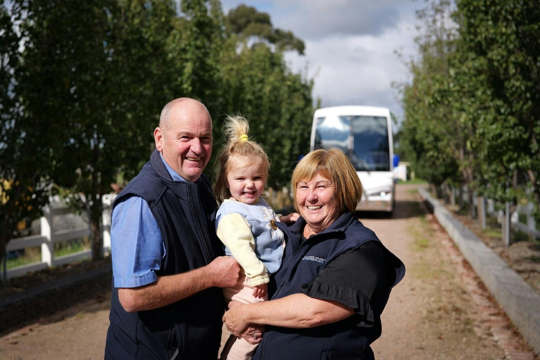 family standing in front of bus