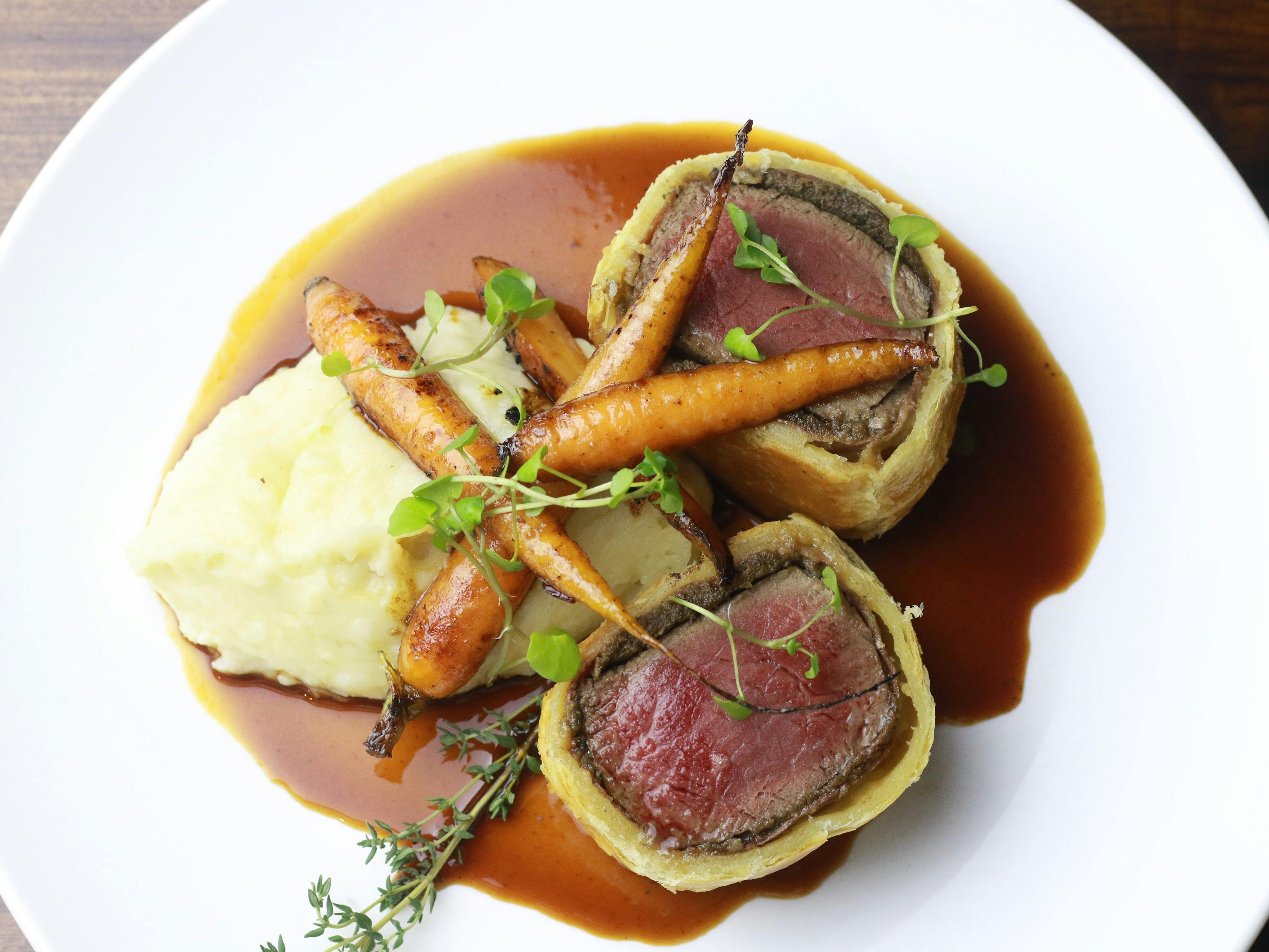 Eye fillet, proscuitto & mushroom pate wrapped in butter puff pastry, served with with garlic & rose