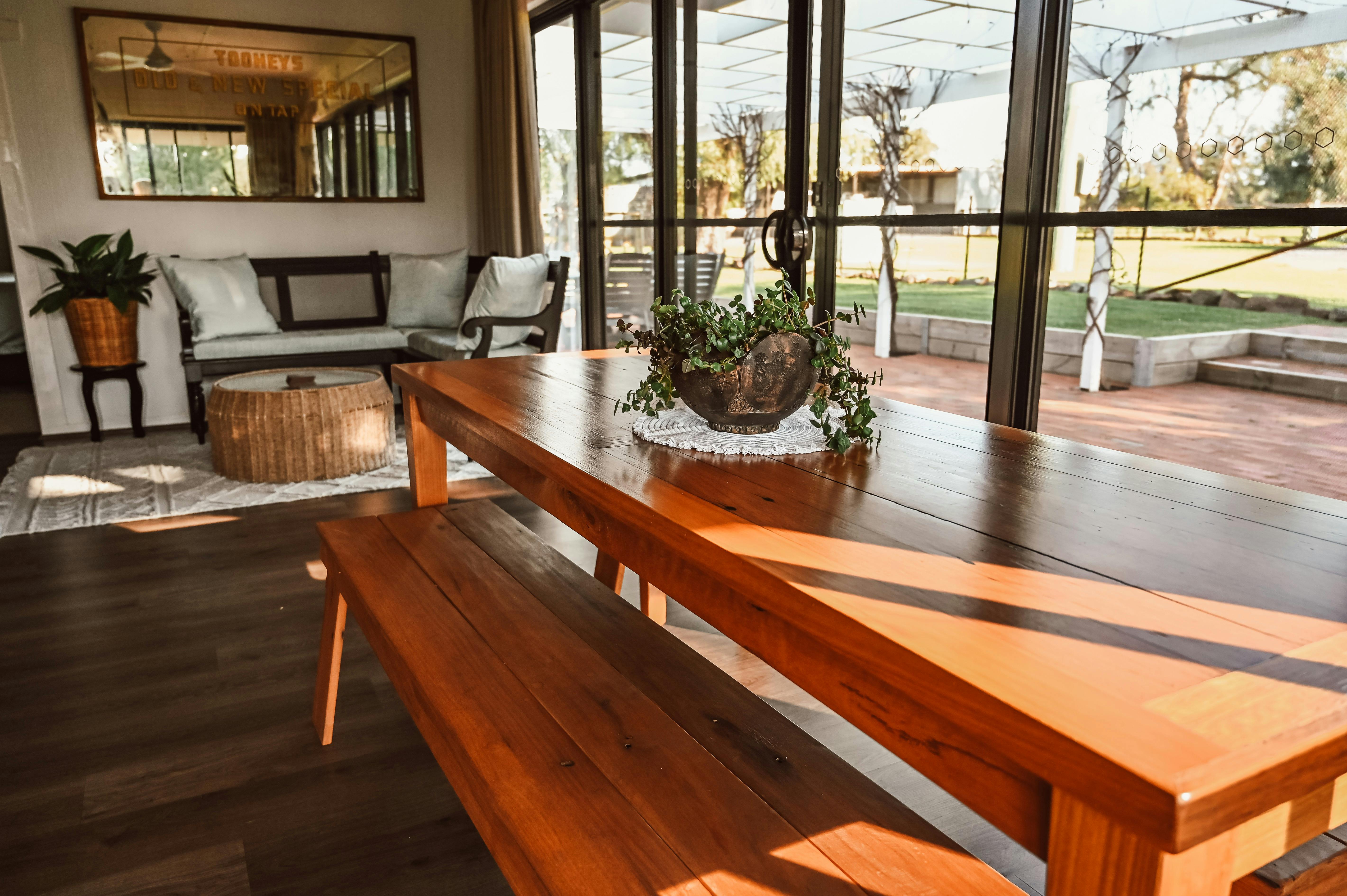 Living area bespoke furnishings, soft earthy pallet, expansive windows looking out to pergola