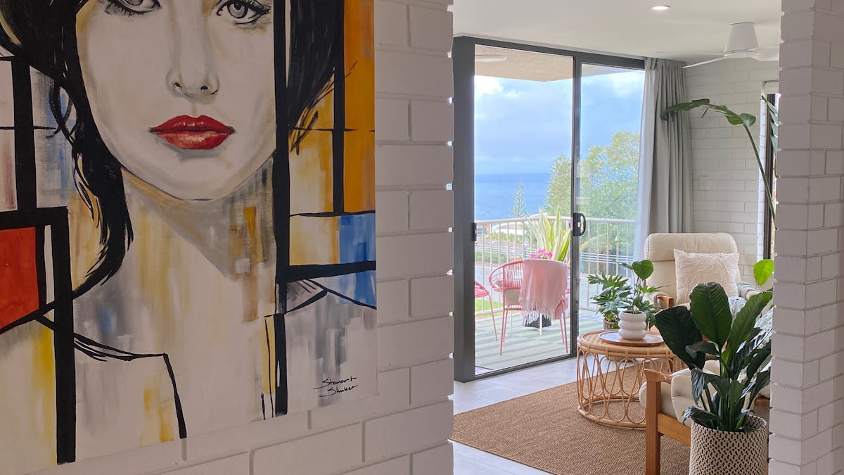 interior close up of woman in a painting, windows and sea view in background