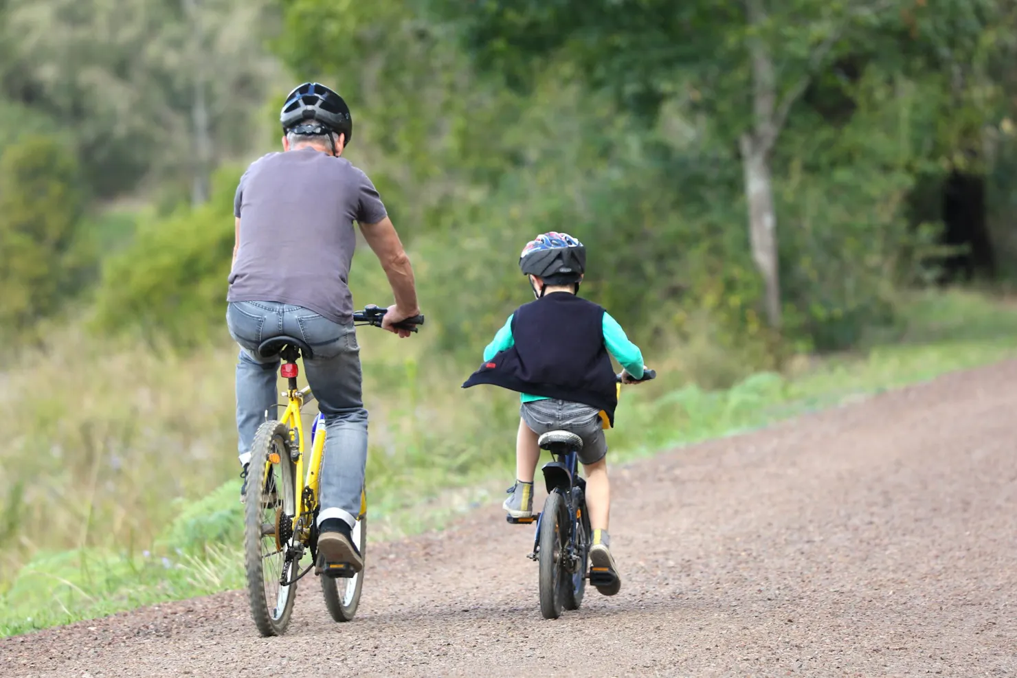 a father and son ride their bikes along the Mary Valley Rail Trail.