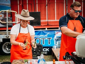 2 cooks in front of cooking station