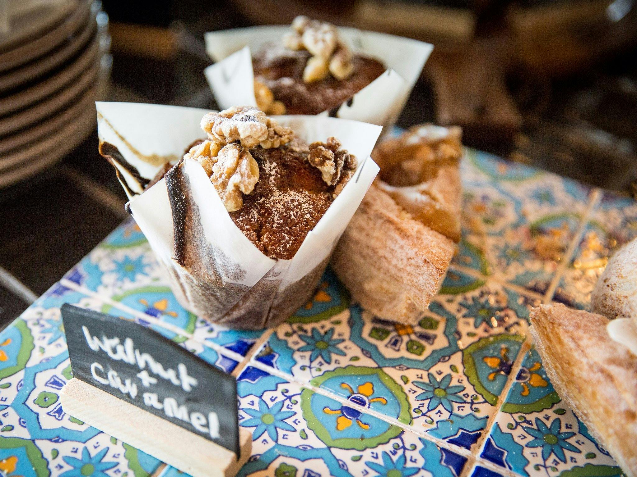 Sweet muffins and pastries on aztec tiles